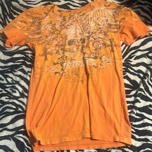 archaic orange shirt cut at the neck